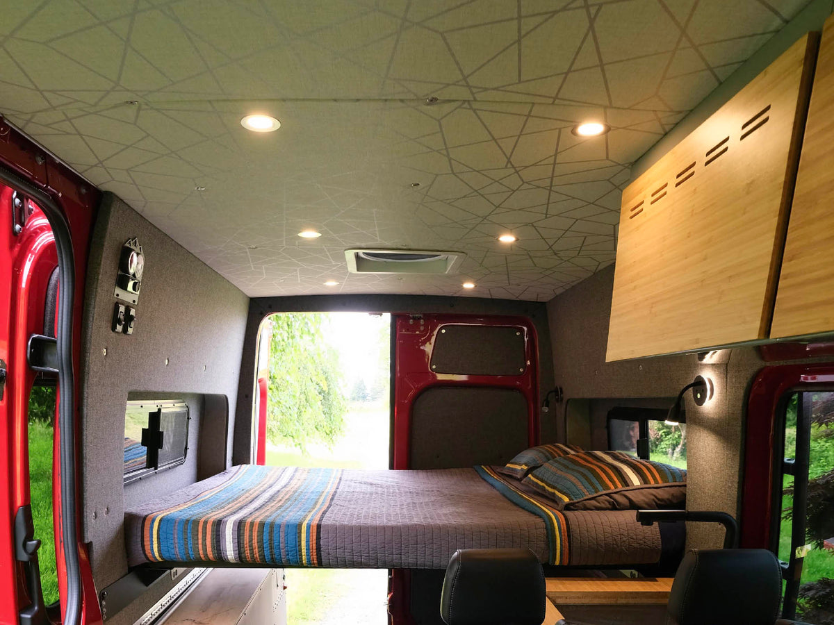 East-West Flarespace bed layout in a Sprinter with mattress and bedding